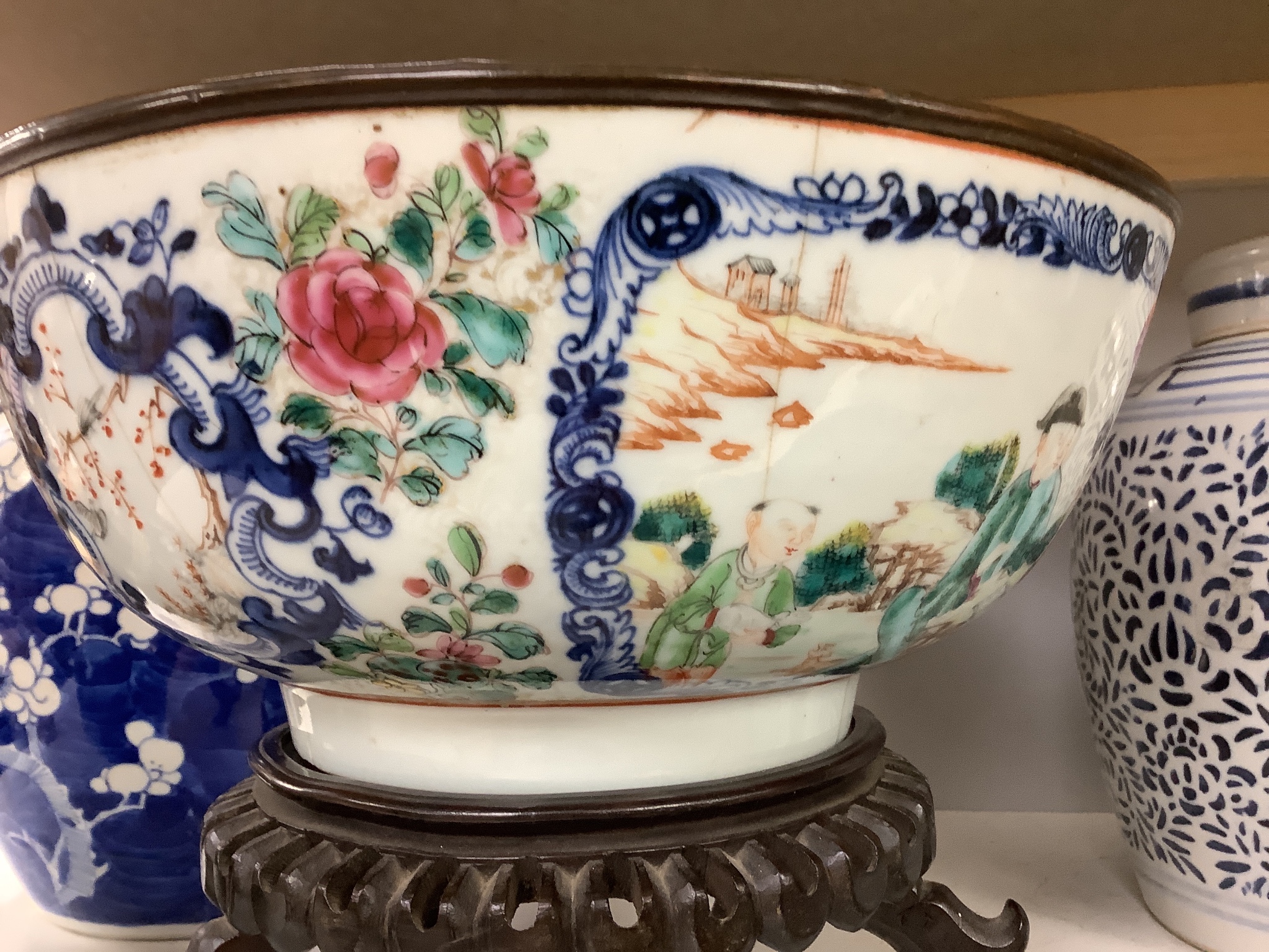 A 19th century Chinese porcelain prunus jar and cover, 27cm, on carved wood stand, a smaller famille noire jar and cover, a Chinese export fruit bowl, blue and white dish and a similar jar and cover 27cm